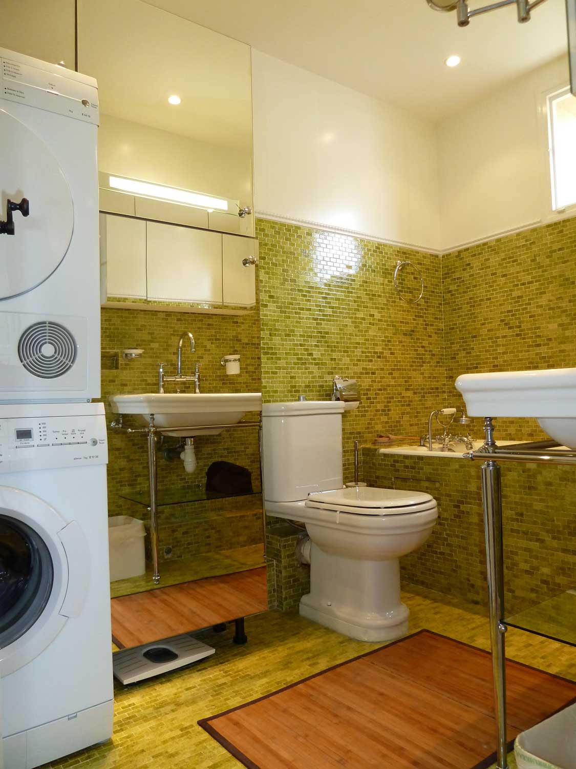 Ensuite bathroom with olive mosaic tiles and laundry stack
