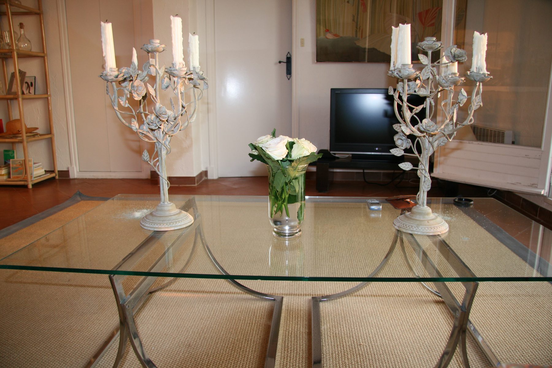 Living room coffee table, candelabra and view toward the terrace doors