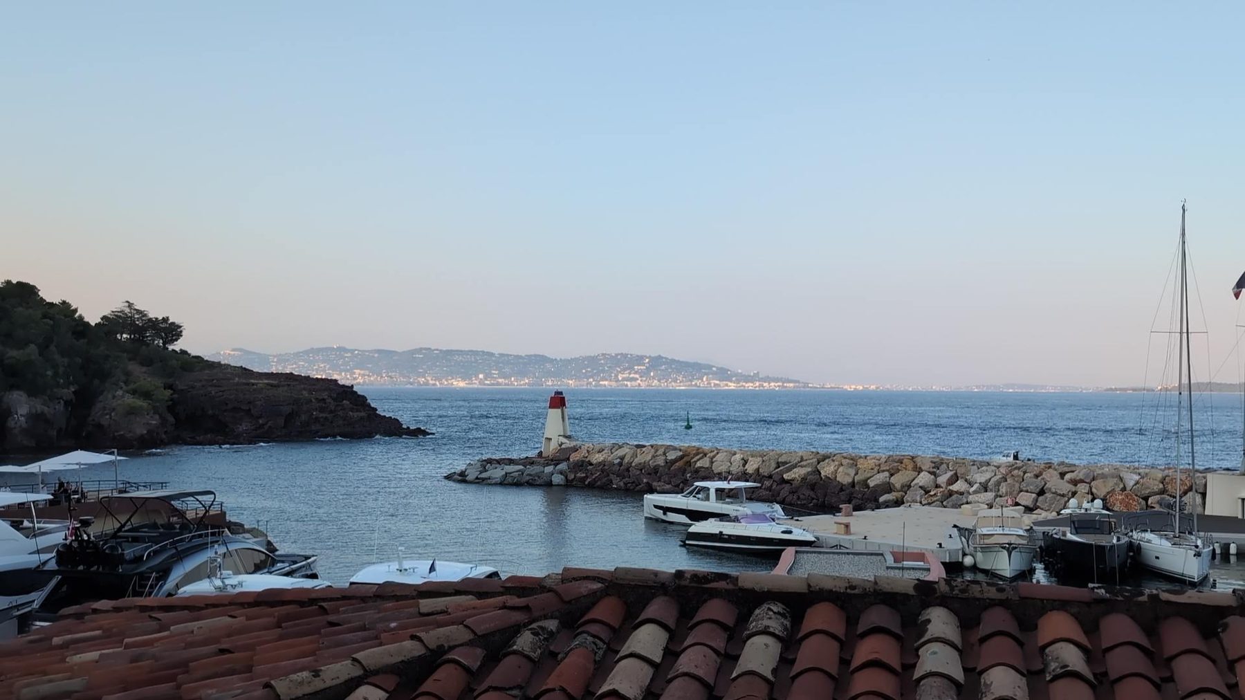Harbour mouth and jetty light from the roofs above the apartment