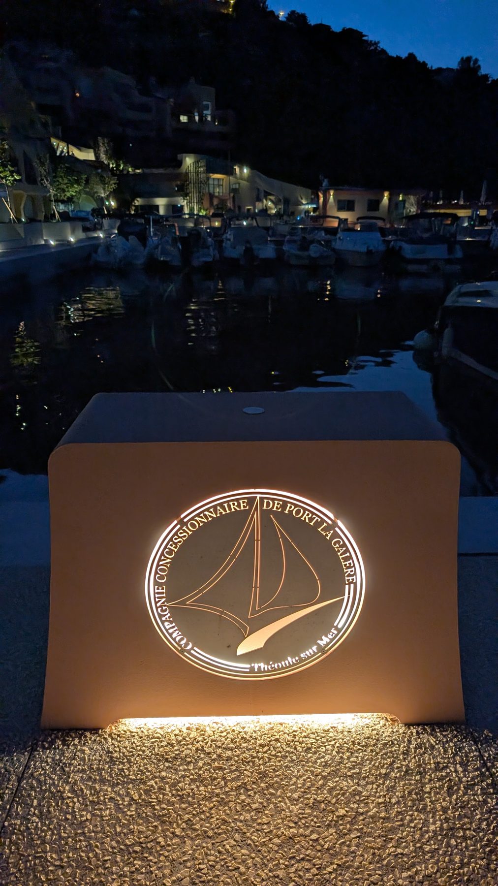 Illuminated Compagnie Concessionnaire de Port La Galère sign at night