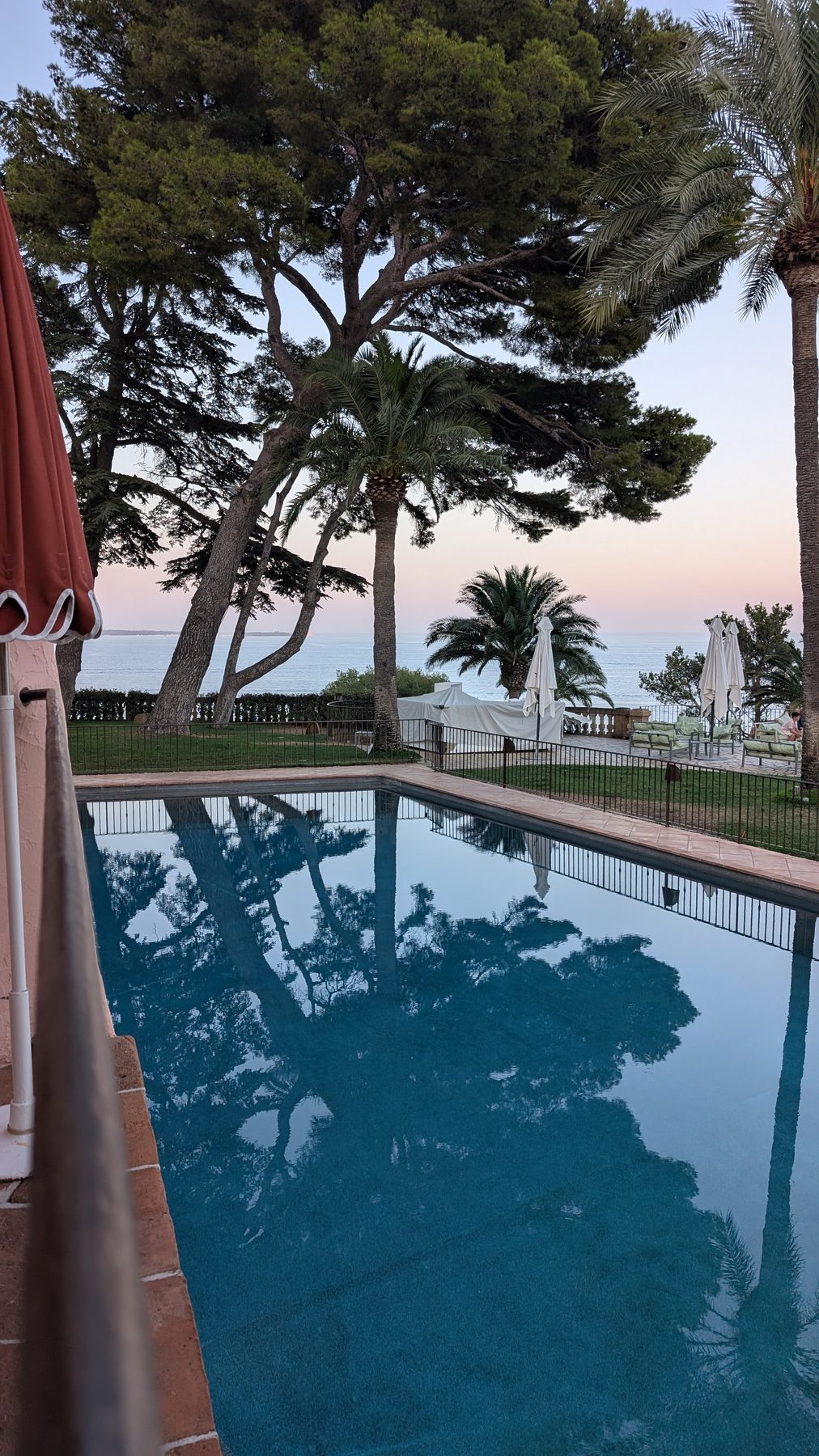 Winter Club pool from the restaurant terrace at dusk